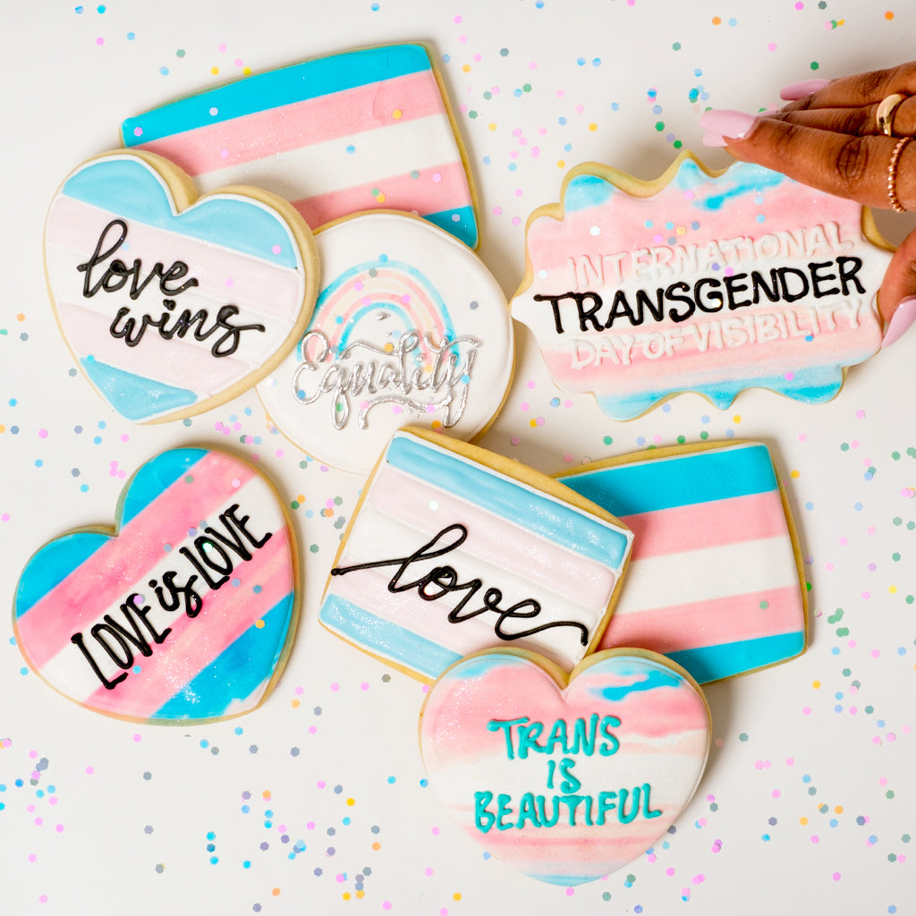 Trans Day of Visibility cookies with pink, white, and blue icing.