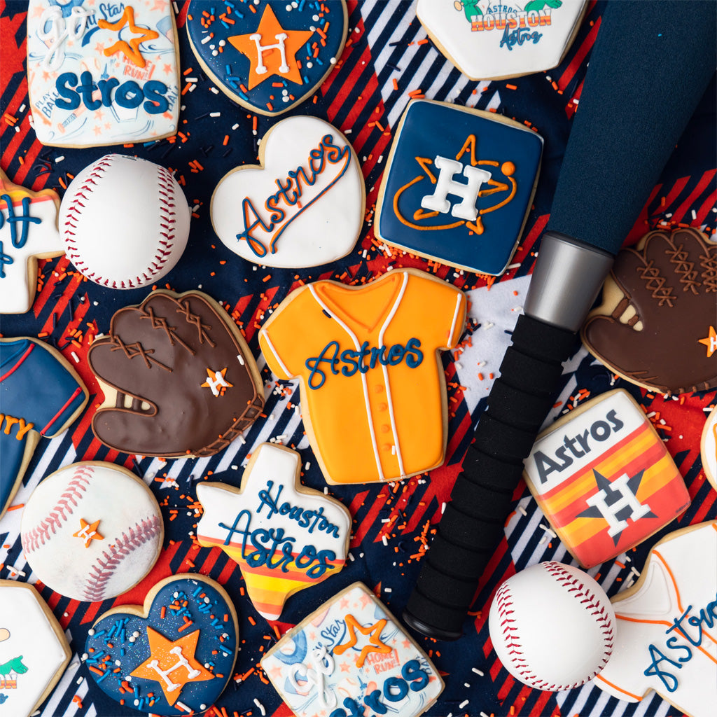 Astros baseball-themed sugar cookies with a bat and balls.