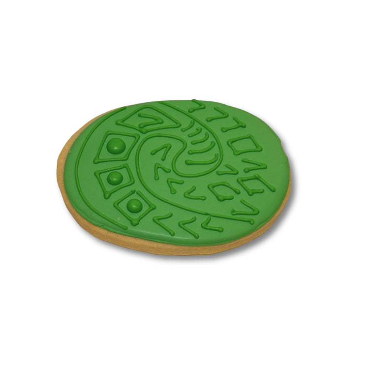 Moana cookie with green icing and spiral heart design.