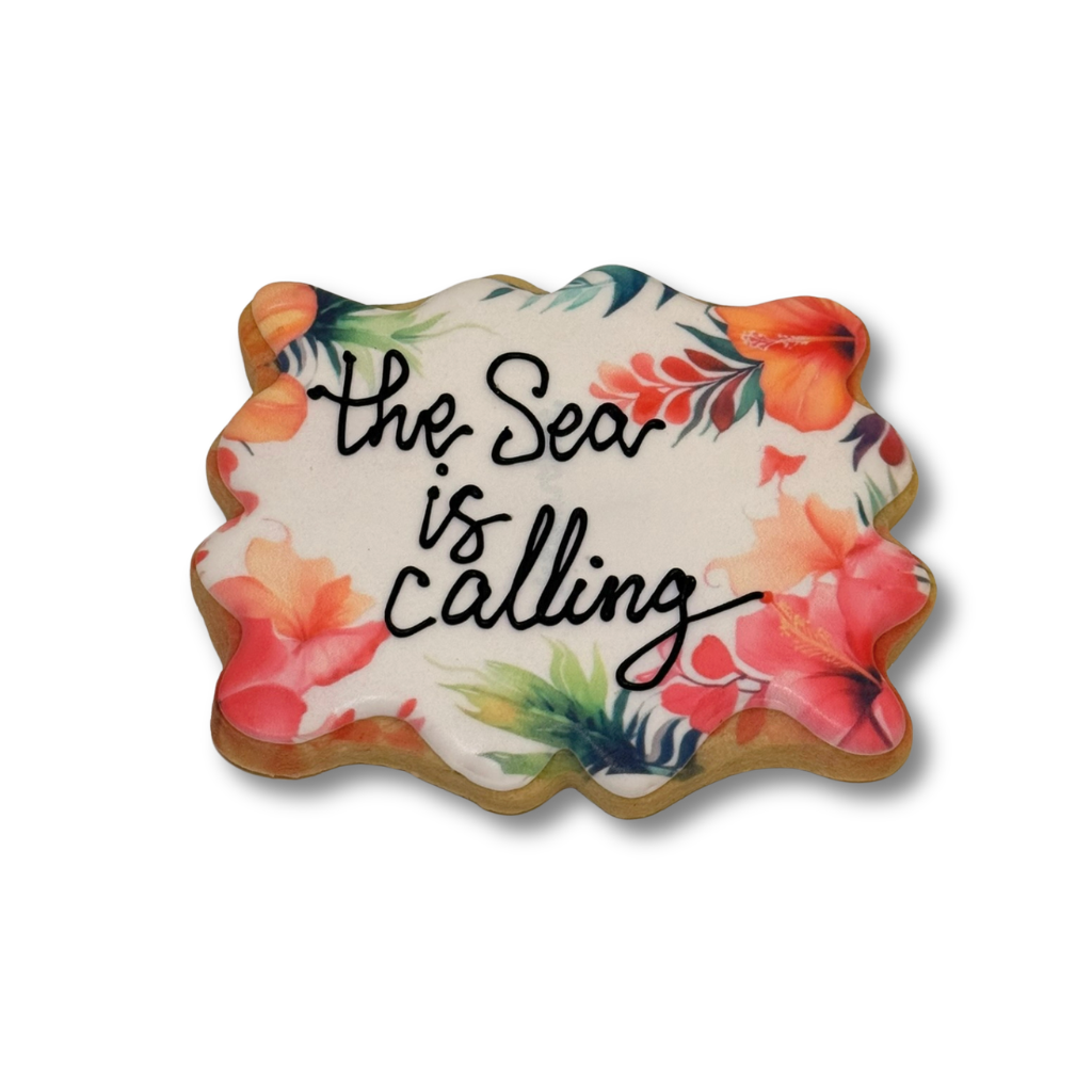 Moana cookie with tropical floral print and script text.