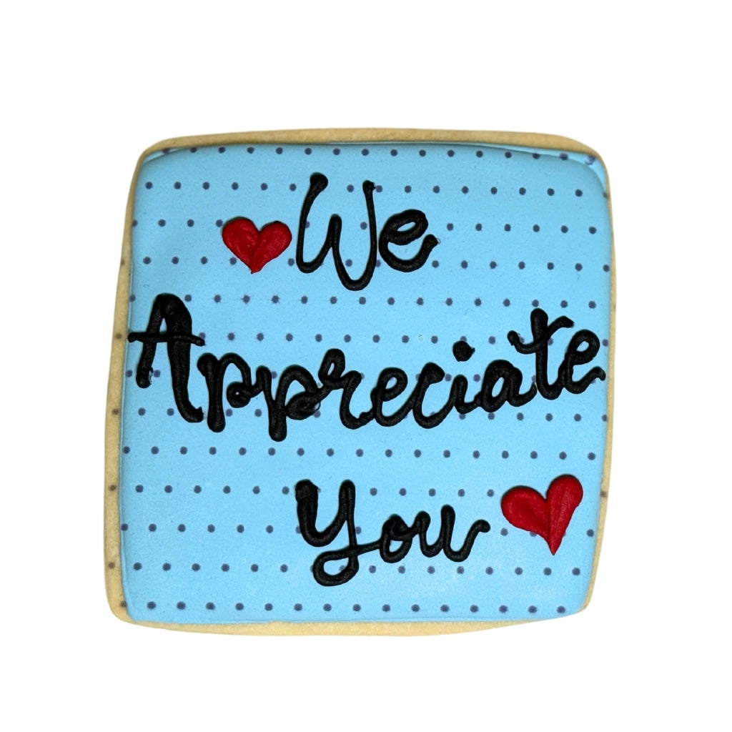 Square Admin Professionals Week cookie with blue polka dot icing.
