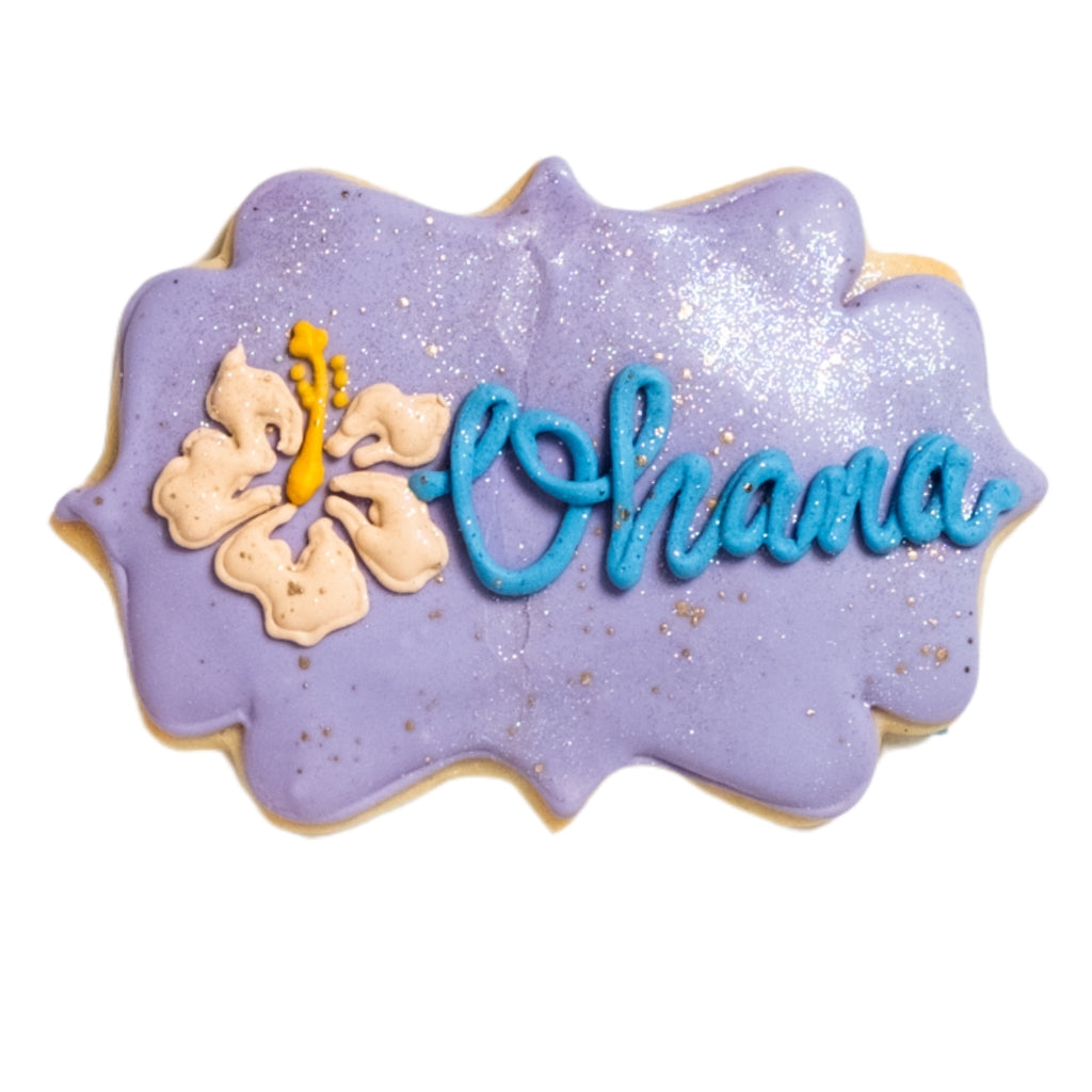 Lilo & Stitch Ohana cookie with purple icing and hibiscus flower.