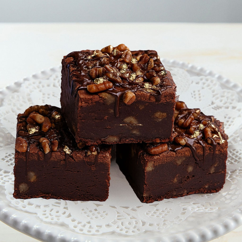 Billionaire brownies topped with pecans and gold leaf.