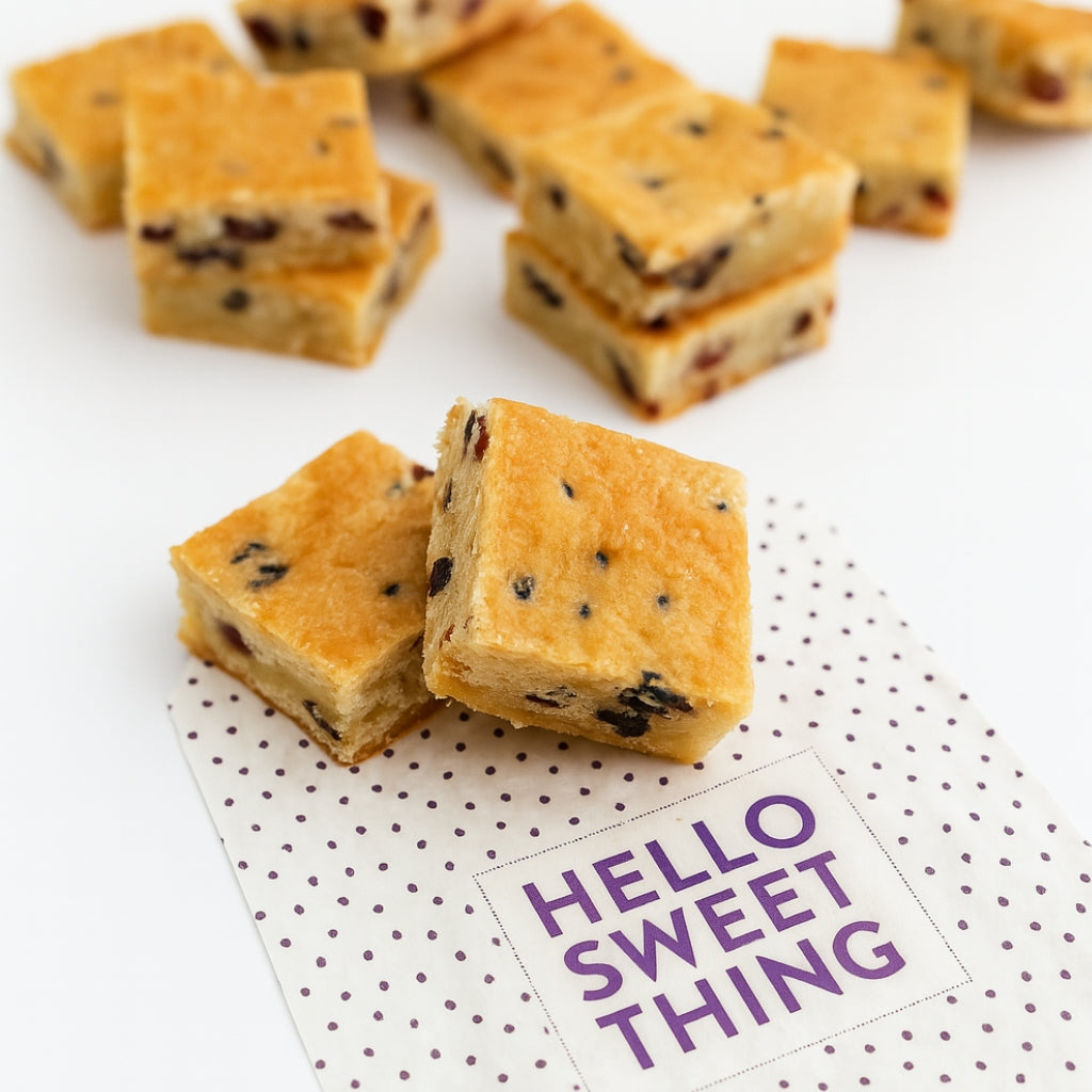 Cranberry white chocolate shortbread squares on a dotted napkin