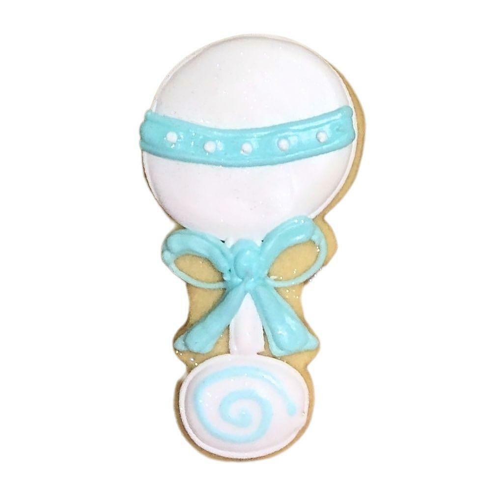 Blue rattle cookie decorated with white and blue icing.