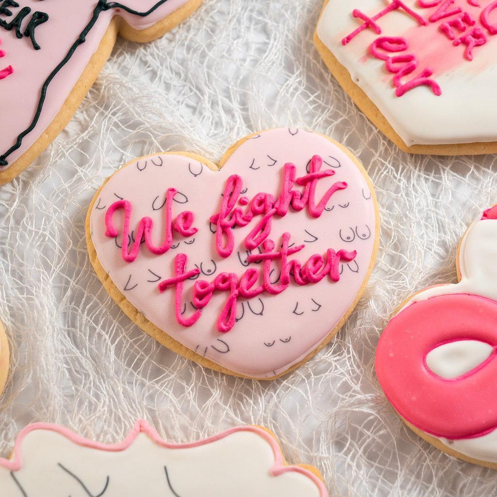 Assorted Breast Cancer Awareness cookies with pink icing.