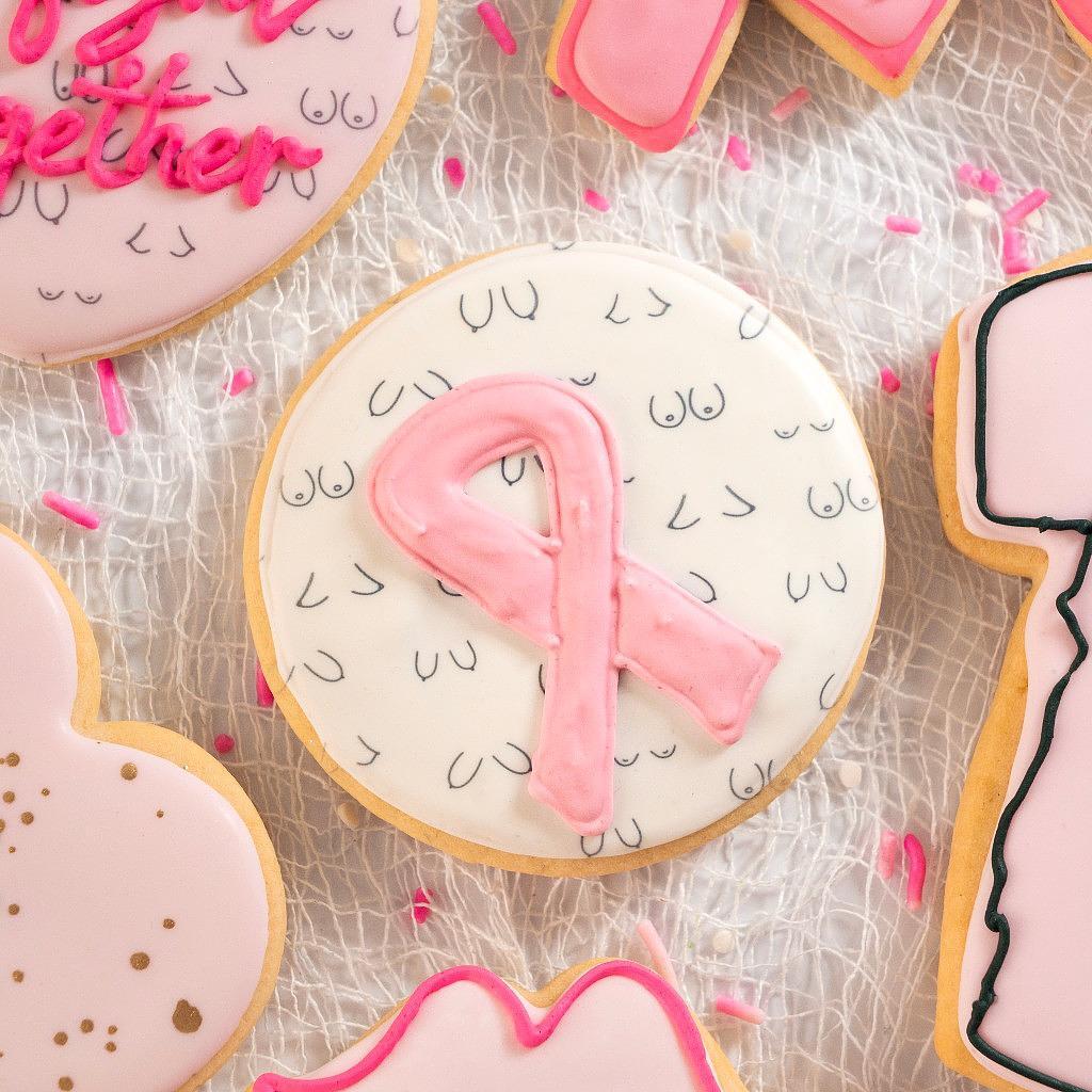 Assorted Breast Cancer Awareness cookies with pink ribbon icing.