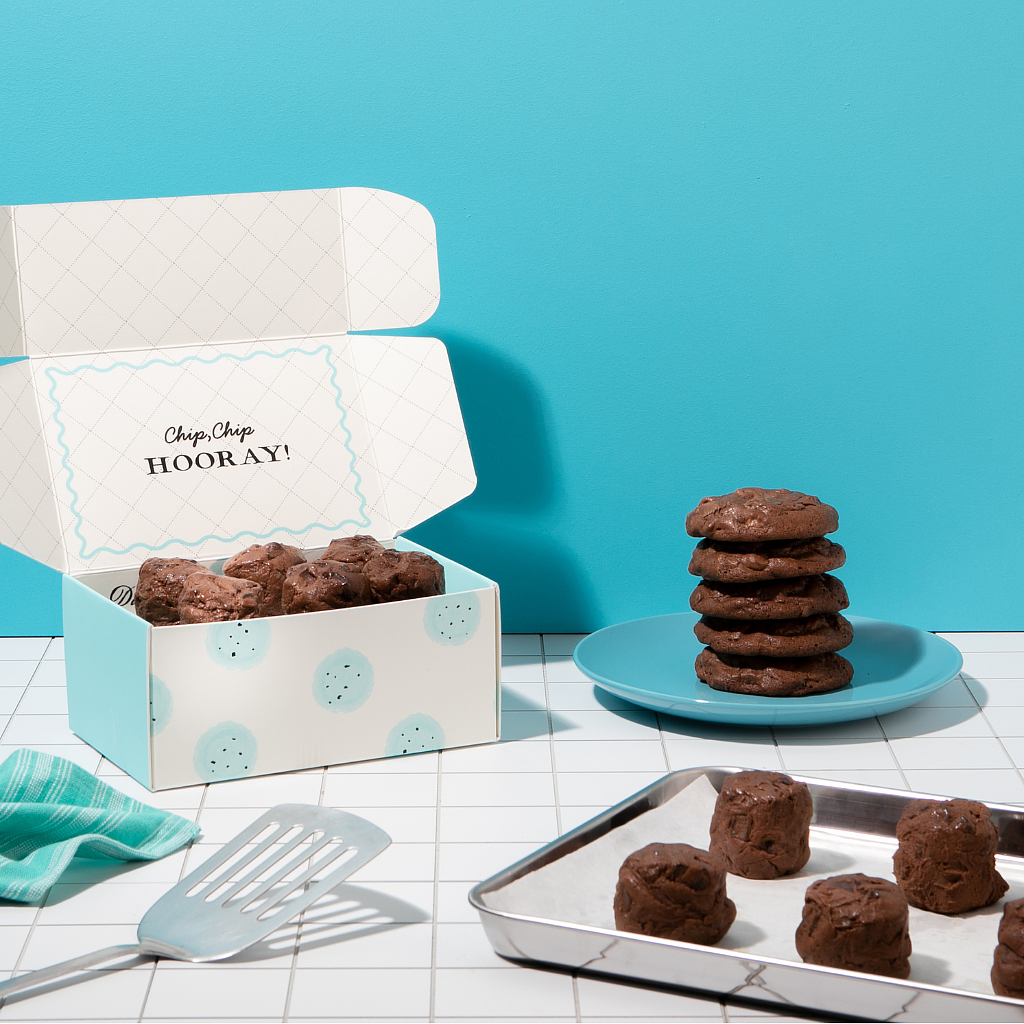 Brookie Dough by DG in a gift box with stacked cookies.
