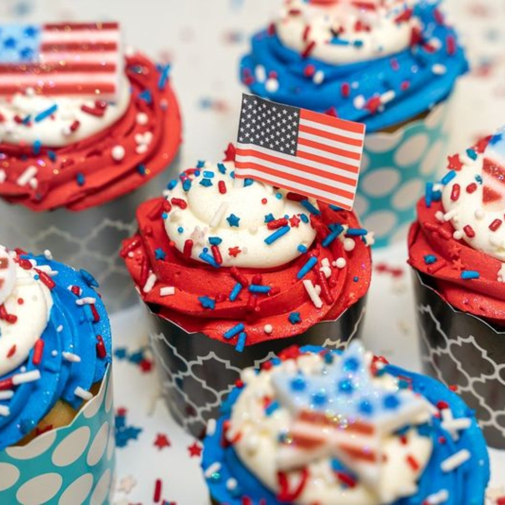 4th of July cupcakes with red, white, and blue frosting and flags.