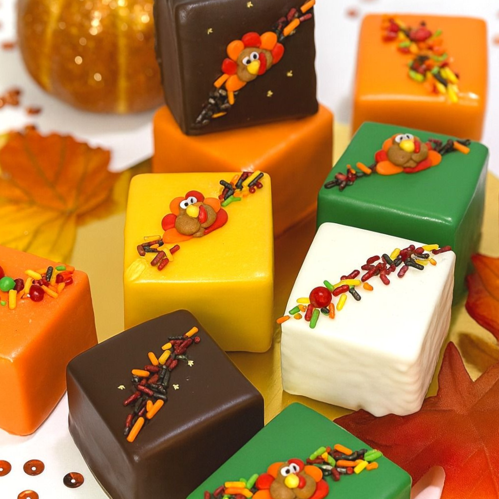 Thanksgiving petit fours with turkey and leaf decorations.