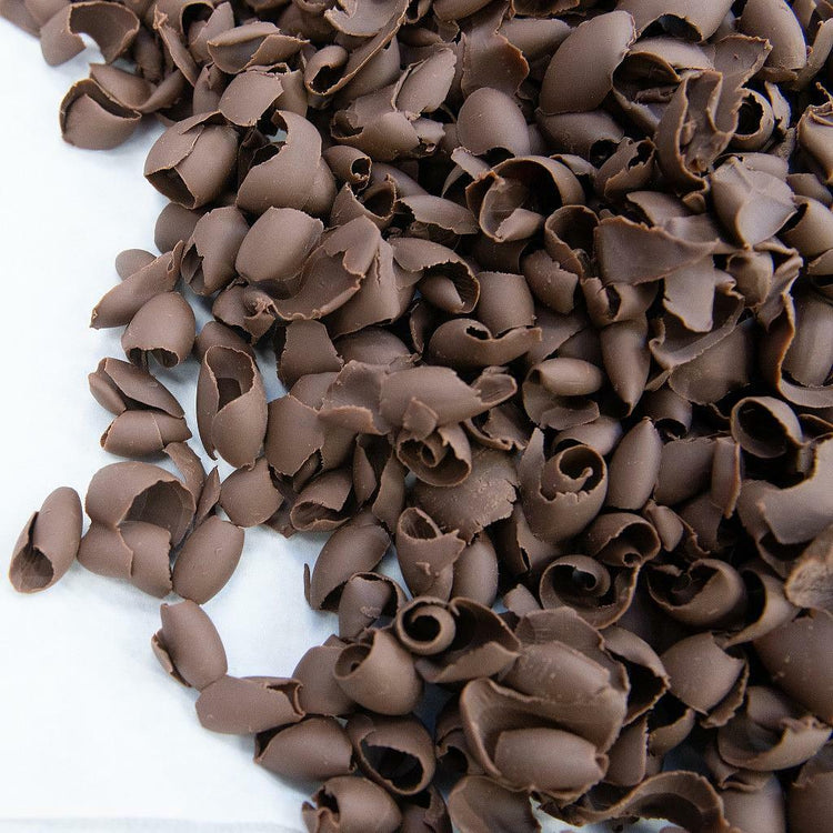 Pile of thin, curled milk chocolate shavings