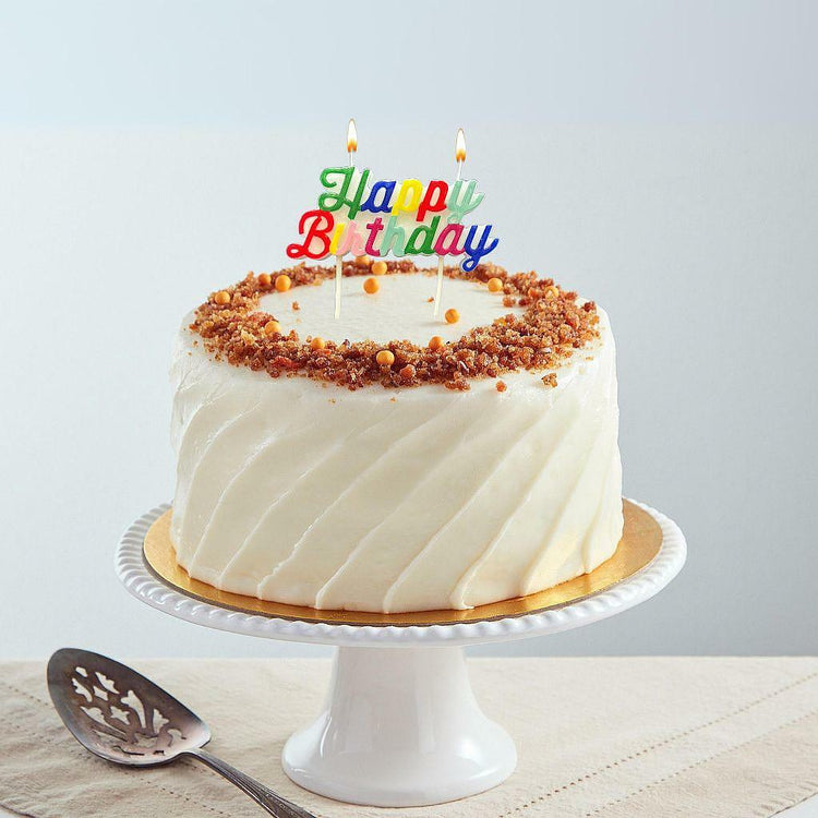 9-inch carrot cake with cream cheese frosting and birthday topper