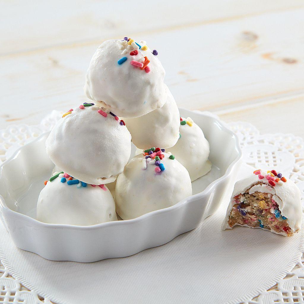 Confetti cake balls in white chocolate with rainbow sprinkles