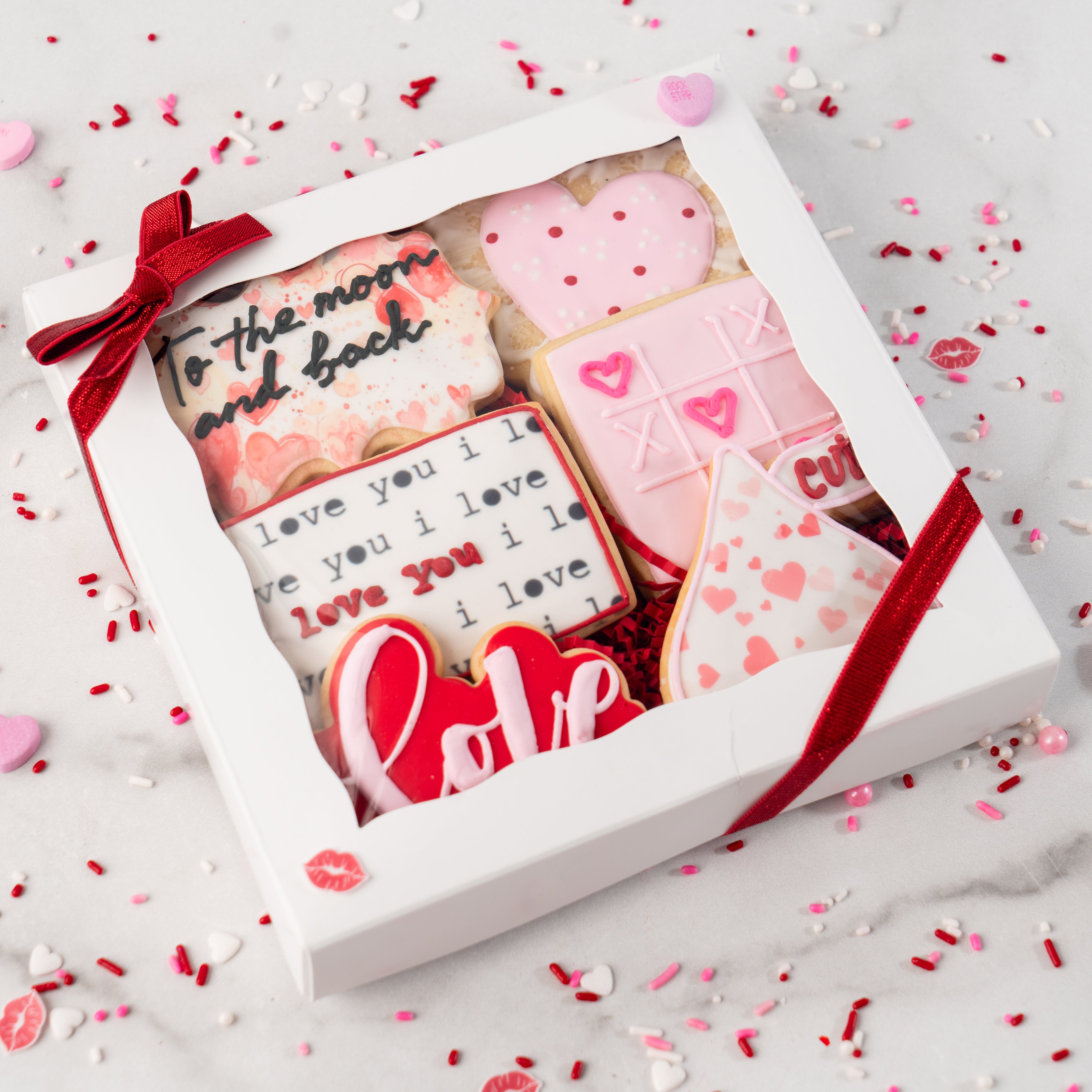 Curated gift box of 6 Valentine cookies with red ribbon.