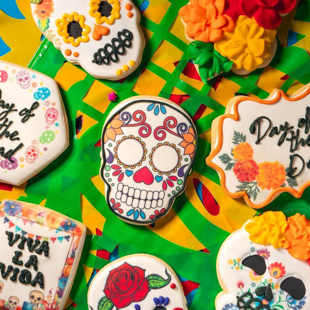 Assorted Day of the Dead cookies with colorful sugar skull icing.