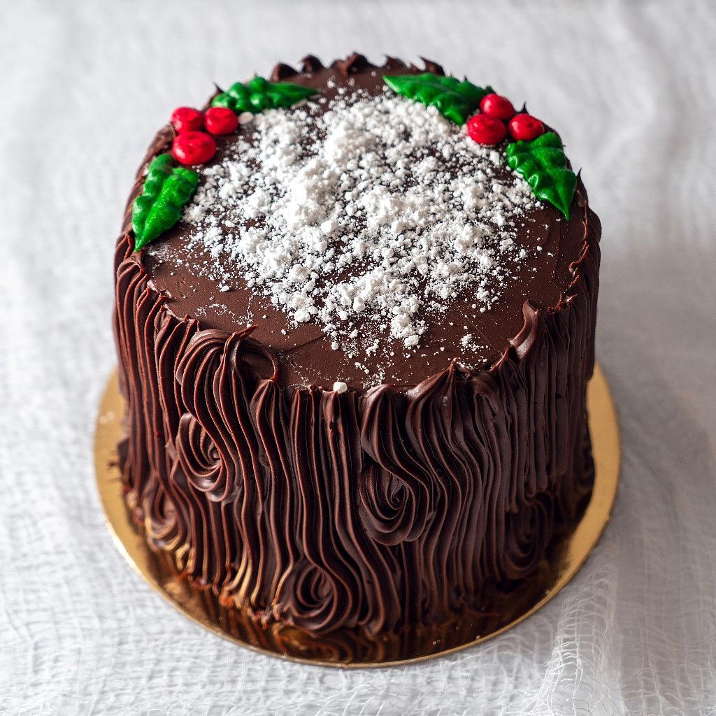 6-inch Yule Log layer cake with chocolate bark frosting.