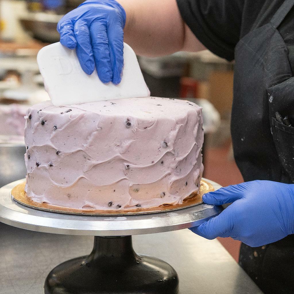9-inch lemon blueberry cake with swirled purple frosting.