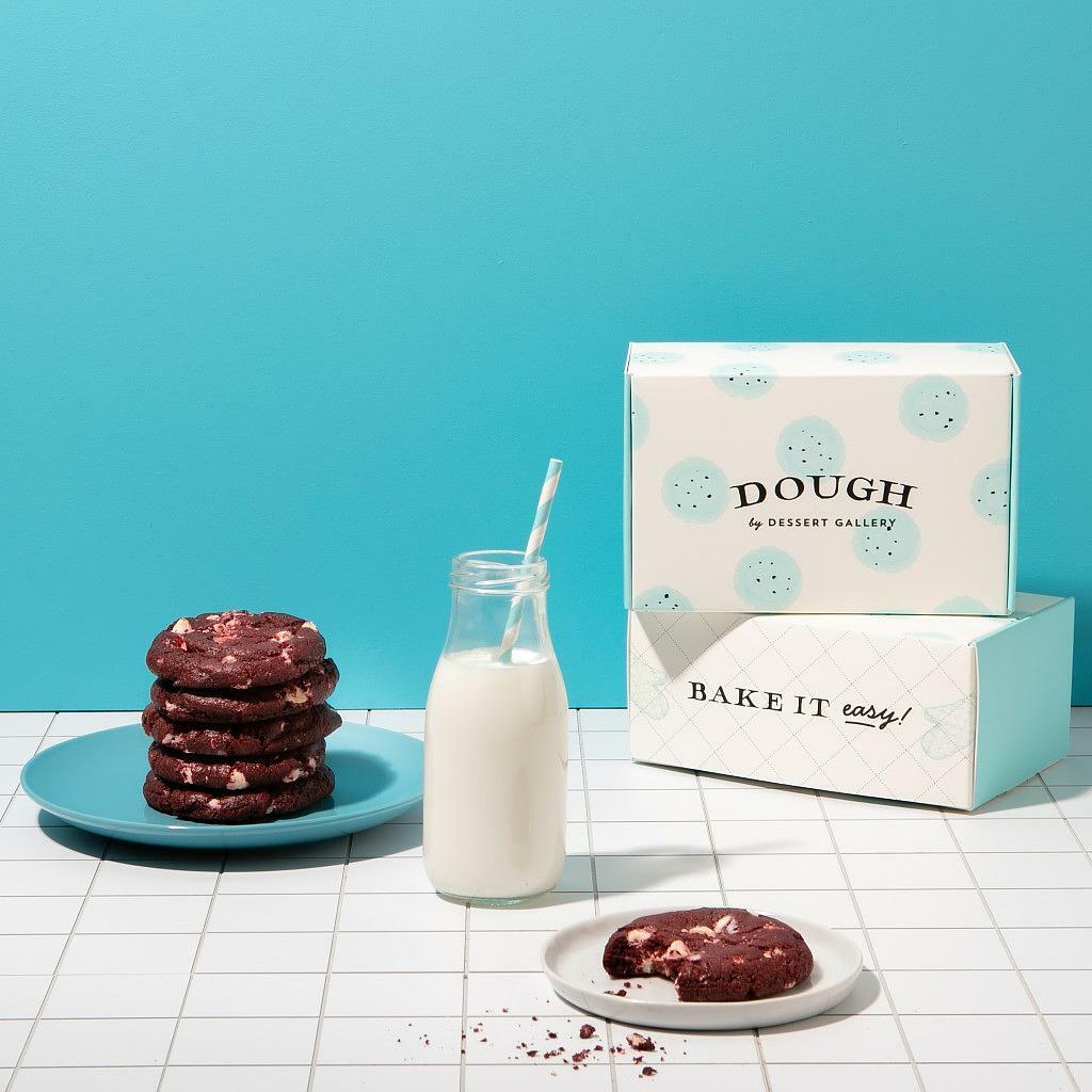 Red Velvet White Chocolate Dough cookies with a glass of milk.
