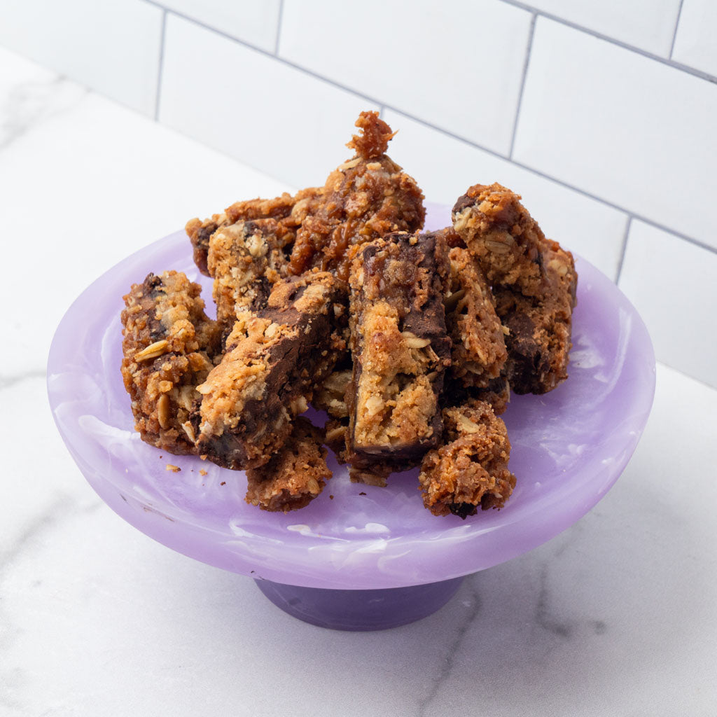 Edges brownie pieces on a purple pedestal stand