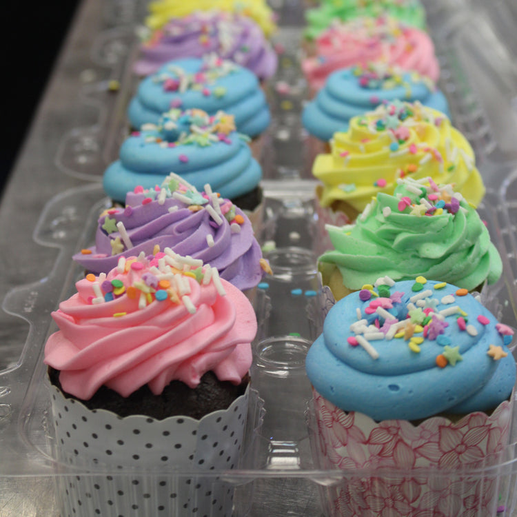 Easter cupcakes with colorful frosting and sprinkles in a tray.