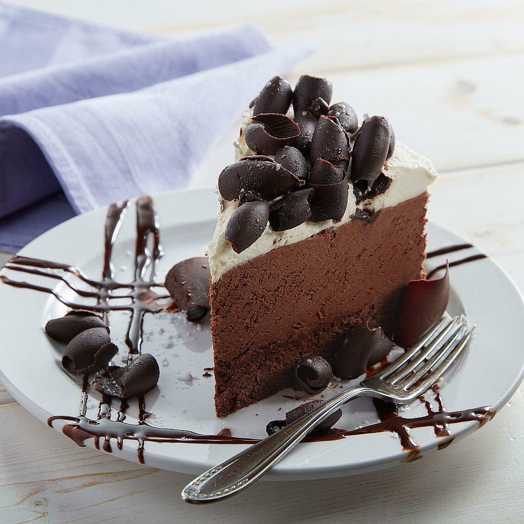 Everyone's Favorite Mousse Cake slice topped with chocolate curls.