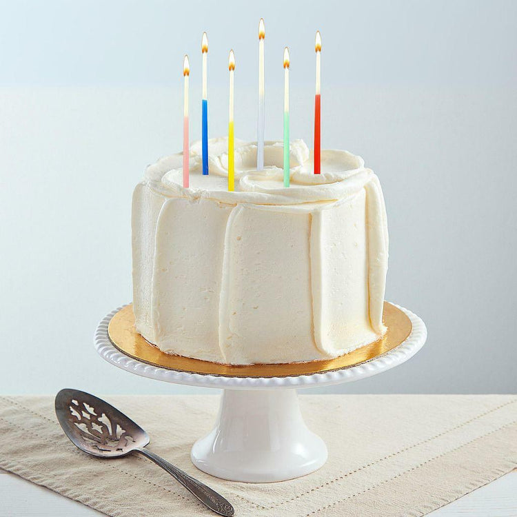 6-inch French vanilla cake with colorful lit candles.