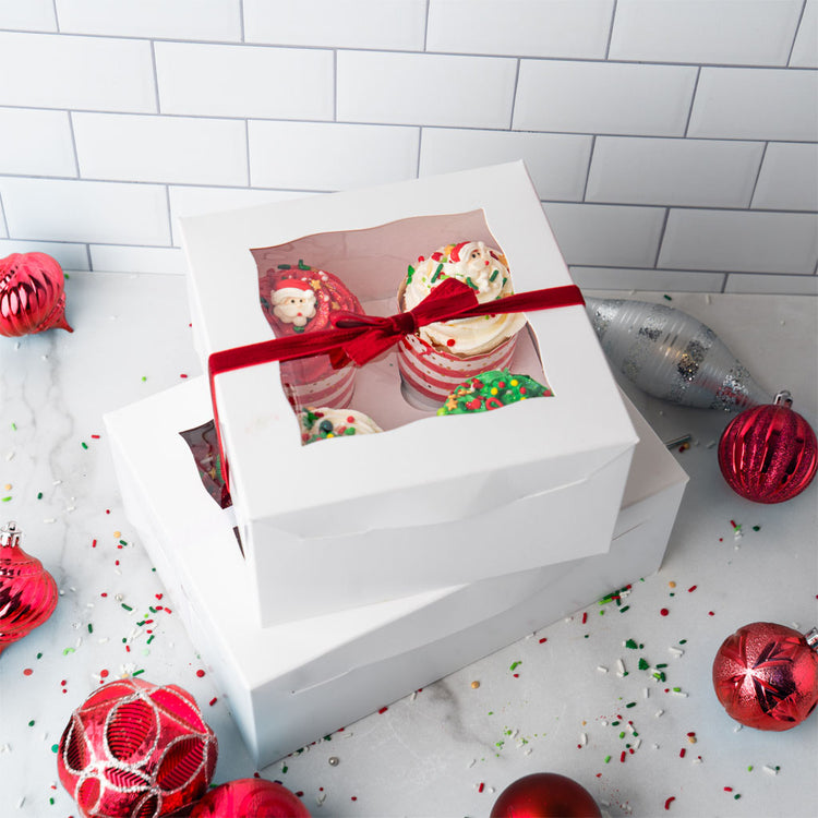 Christmas Cupcake Collection in white boxes with red ribbons.