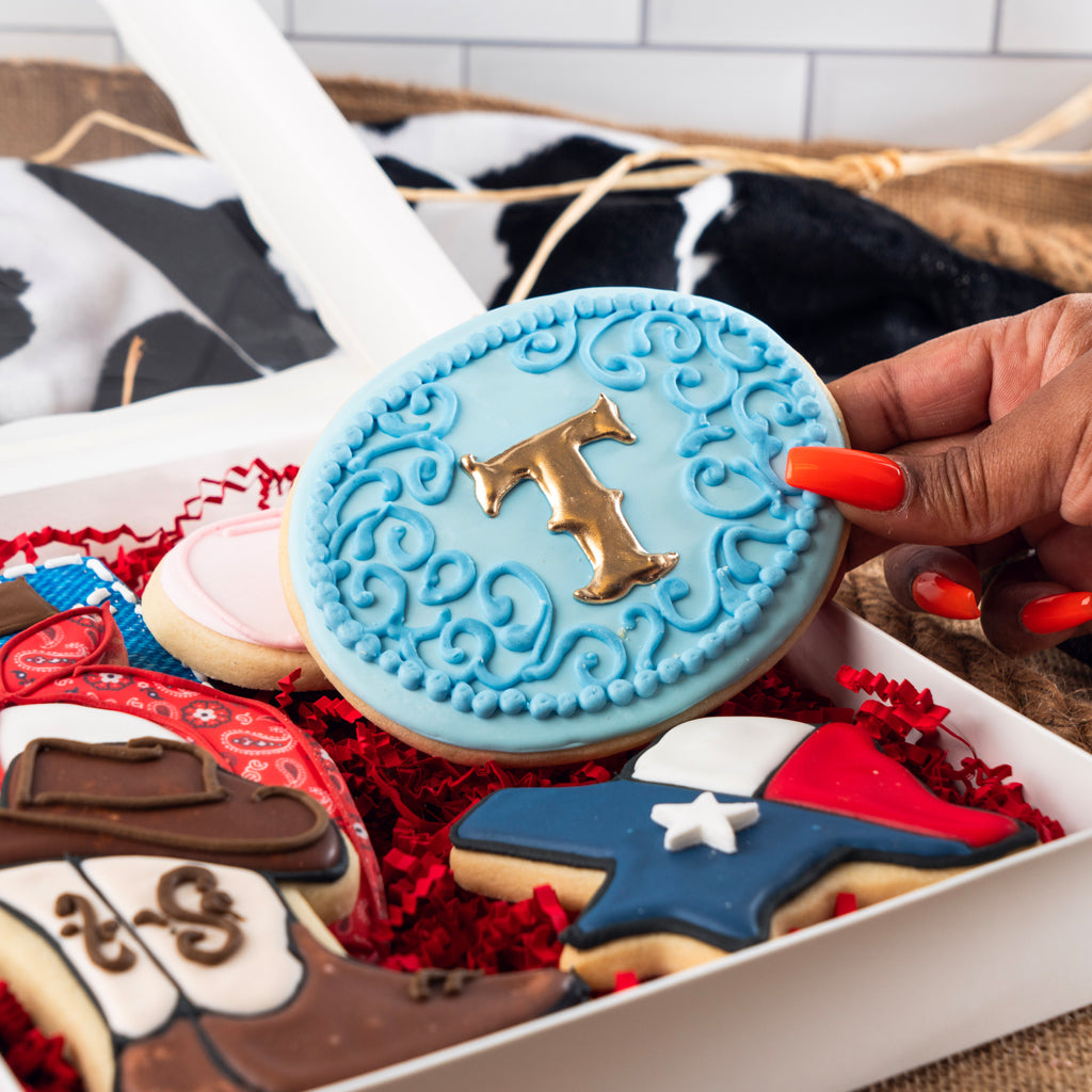 Rodeo theme gift box with decorated letter and boot cookies