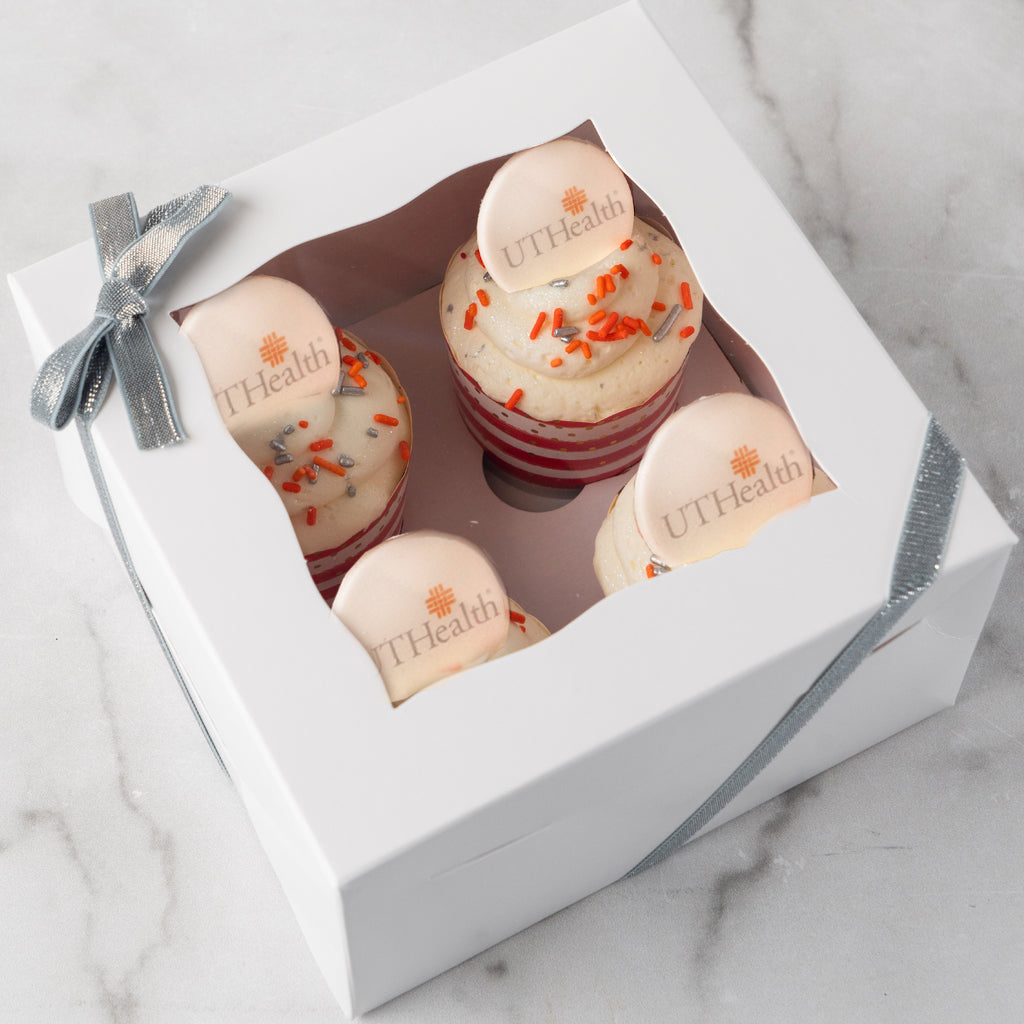 4-pack logo cupcakes in a white gift box with silver ribbon.