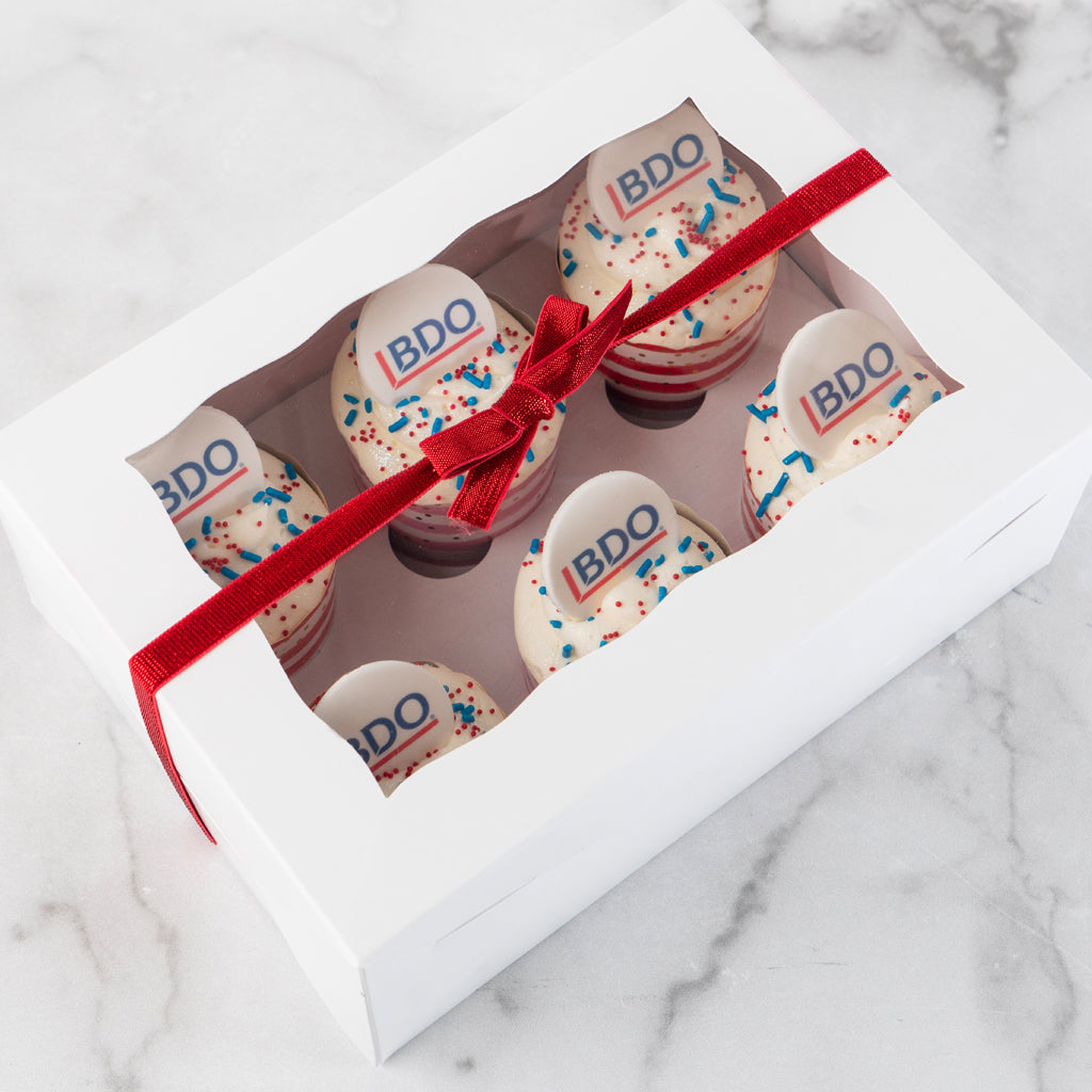 6-pack logo cupcakes in a white gift box with red ribbon