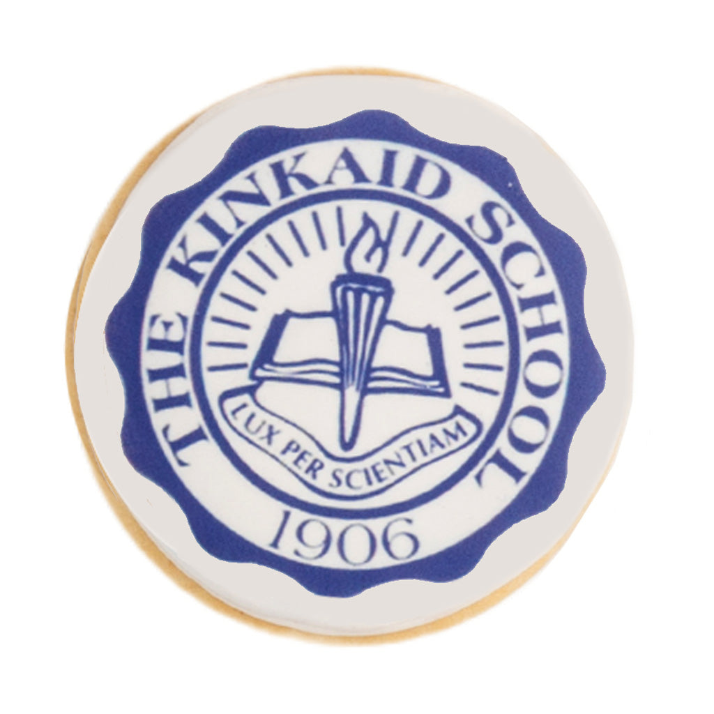 Round graduation cookie with blue Kinkaid School logo.