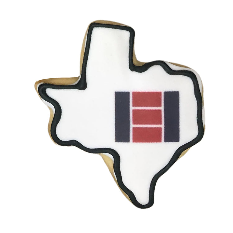 Texas-shaped logo cookie with white icing and black outline