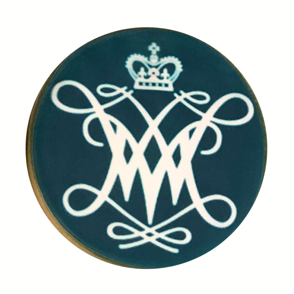 Round photo cookie with a white royal monogram on teal icing.