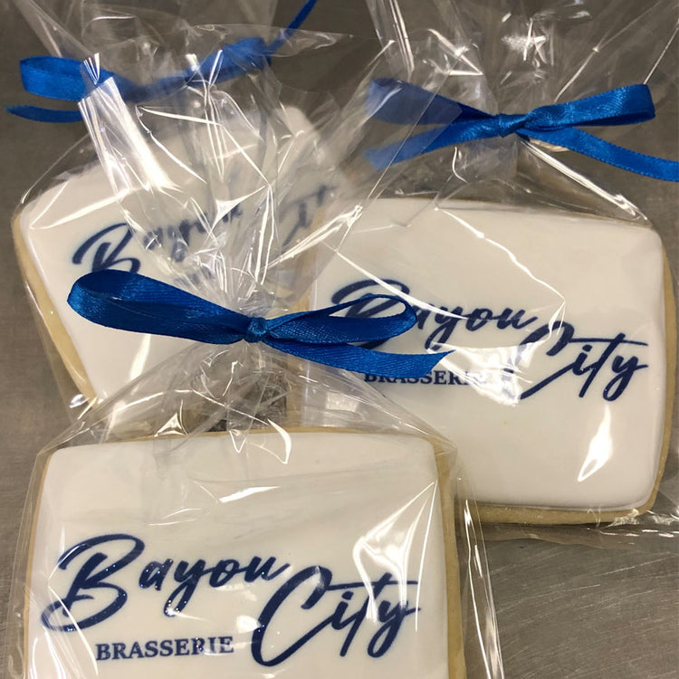 Business card logo cookies in clear bags with blue ribbons