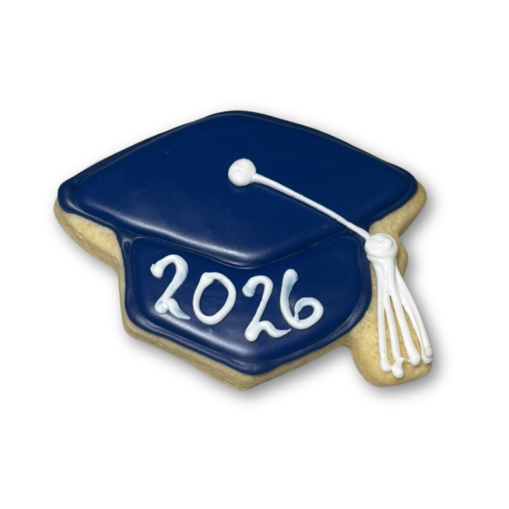 Graduation cap cookie with blue icing and 2026 text.