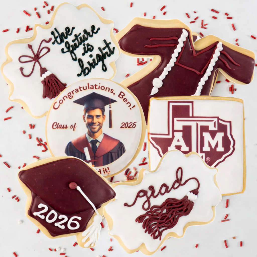 Graduation cookie gift box with maroon and white icing designs.