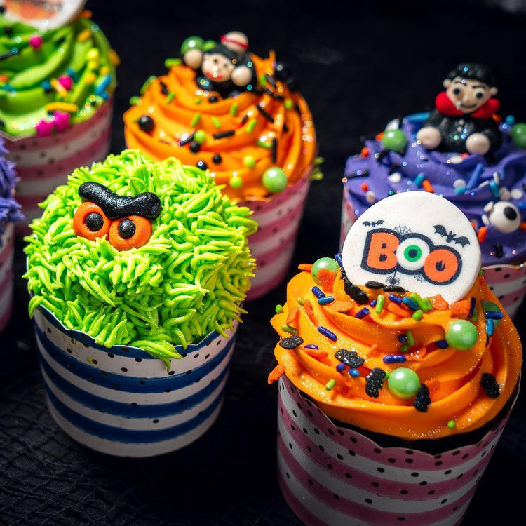 Halloween cupcakes with colorful frosting and spooky toppers