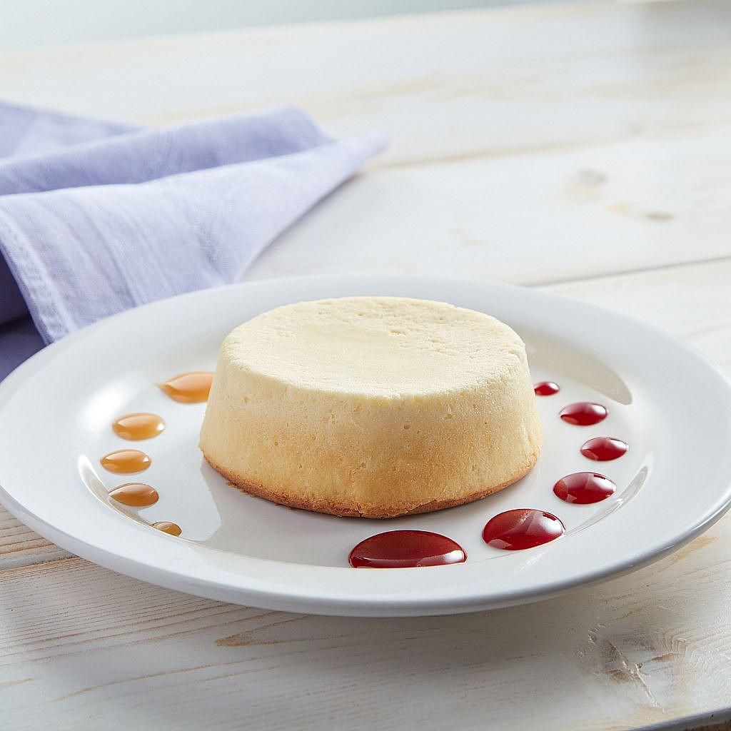Individual keto-friendly cheesecake with berry sauce dots