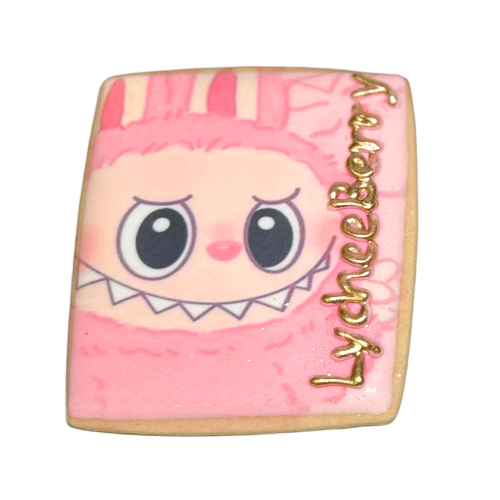 The Monsters Cookies with pink furry monster and gold lettering.
