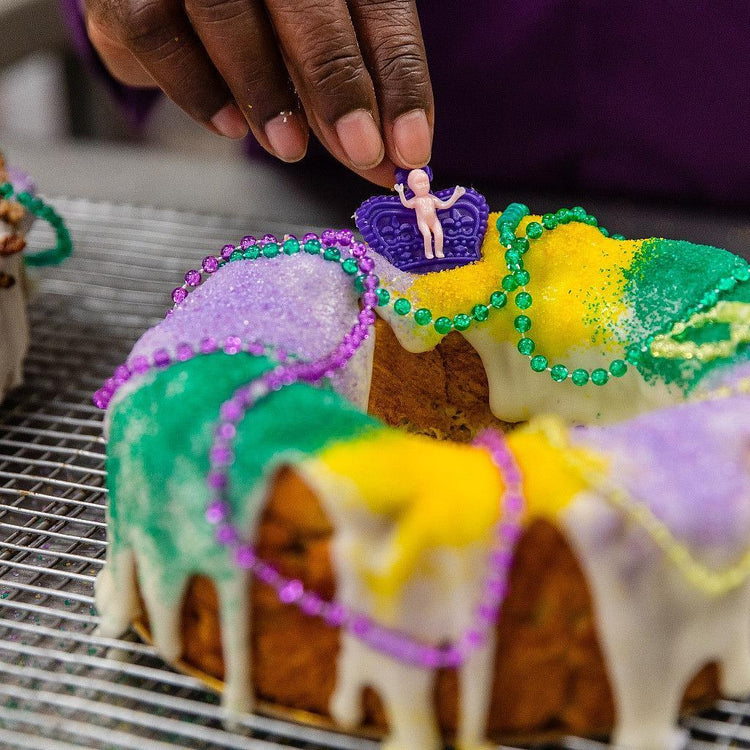 Mardi Gras 2025 king cake with purple, green, and gold sugar.