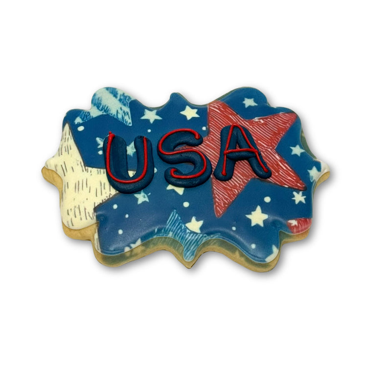 Memorial Day cookie with blue USA icing and star patterns.