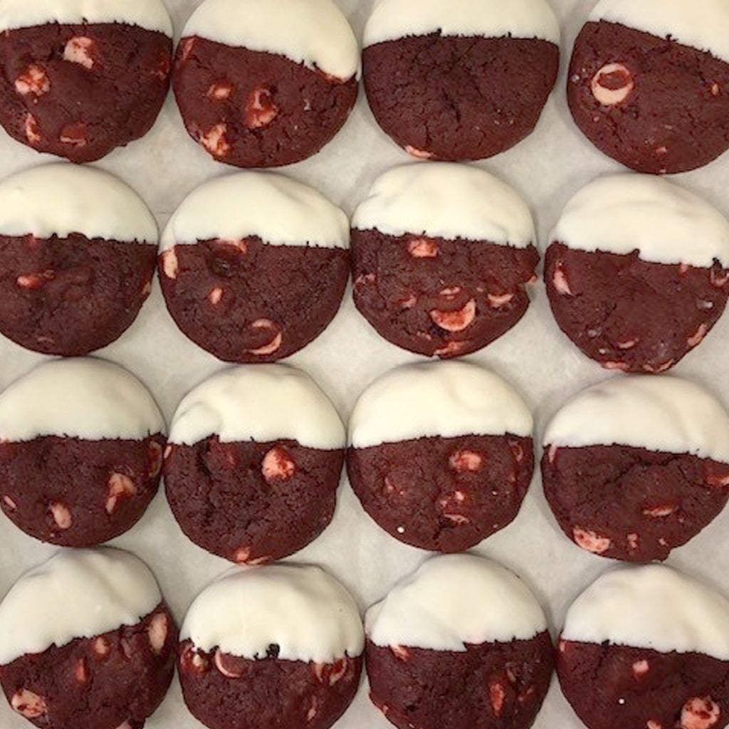 Miniature red velvet cookies dipped in white chocolate.