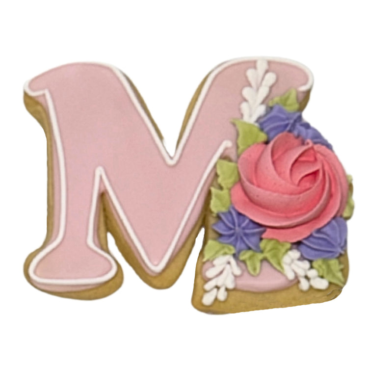 Mother's Day letter M cookie with pink and purple frosting.