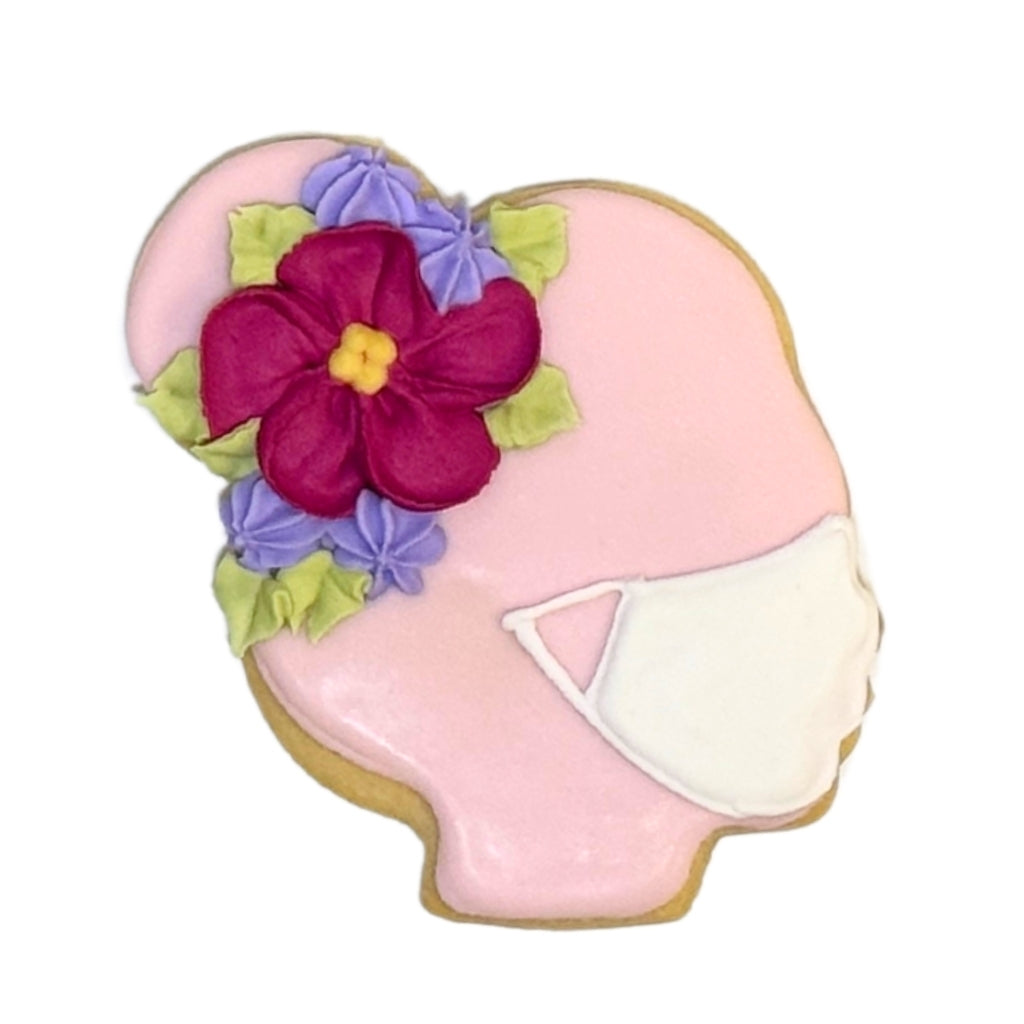 Nurse Appreciation Week cookie shaped like a head with a mask.