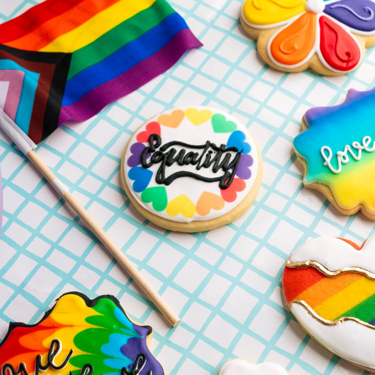Assorted Pride cookies with colorful icing and a rainbow flag.