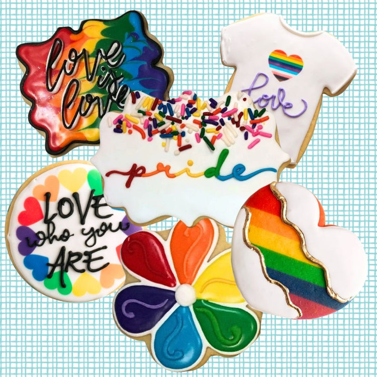 Assorted Pride cookies with colorful rainbow icing designs.