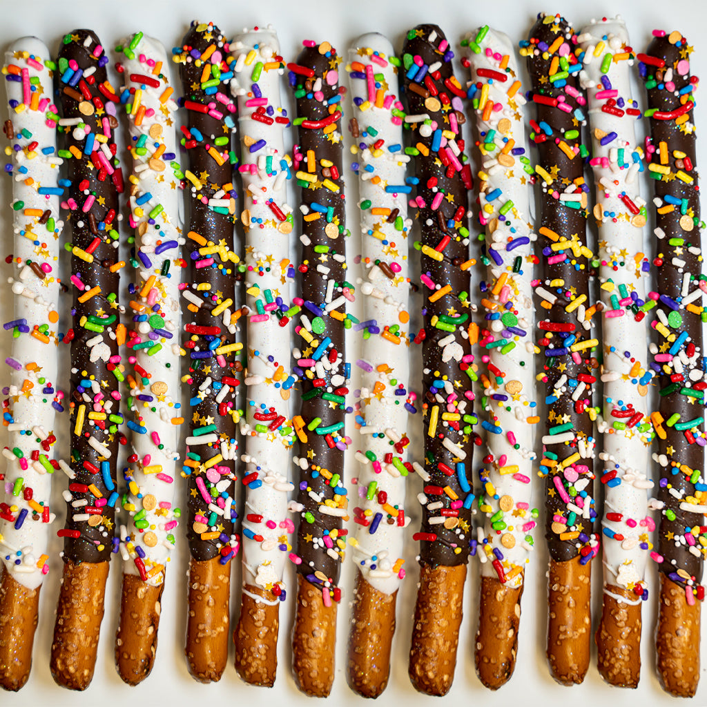 Pride Pretzels dipped in dark and white chocolate with sprinkles.