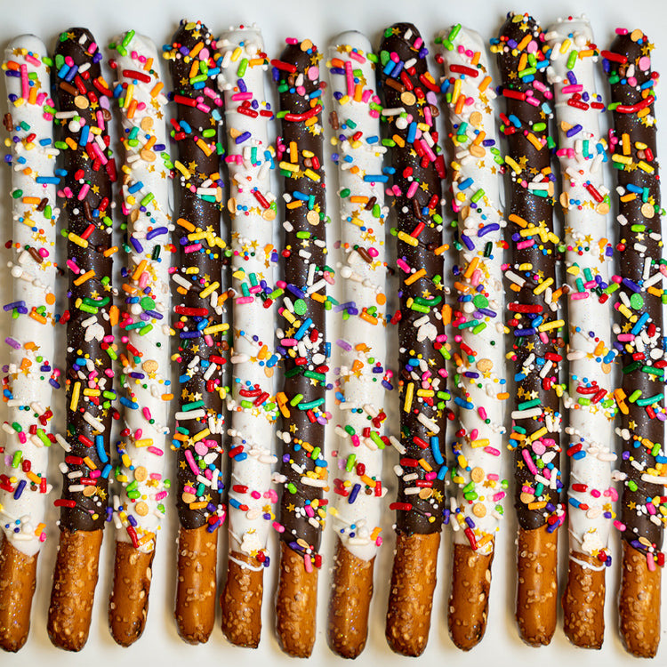 Pride Pretzels dipped in dark and white chocolate with sprinkles.