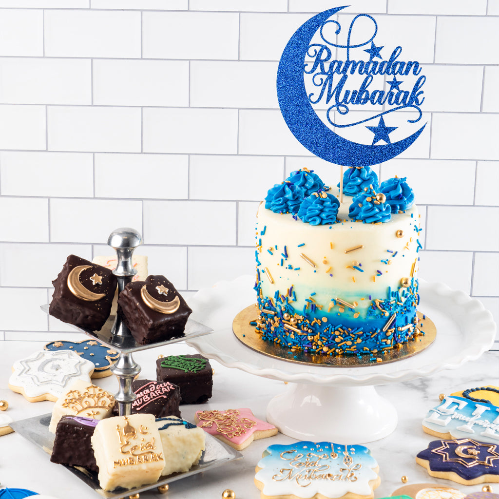 Ramadan Mubarak cake with blue crescent topper and cookies