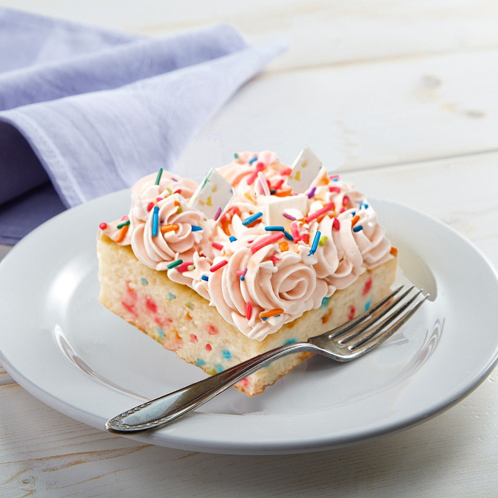 Funfetti slab cake with pink frosting and colorful sprinkles